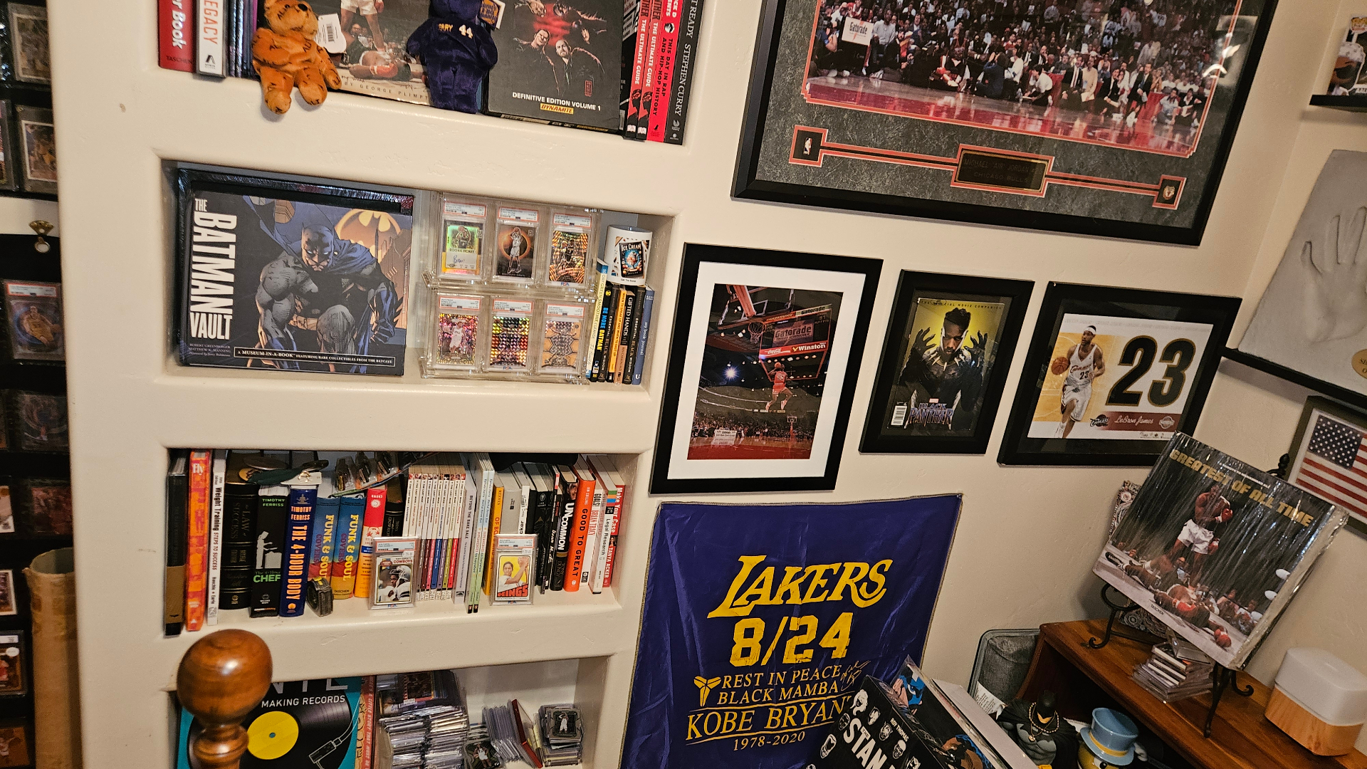 Built-in shelves with comics, books, and slabbed cards.