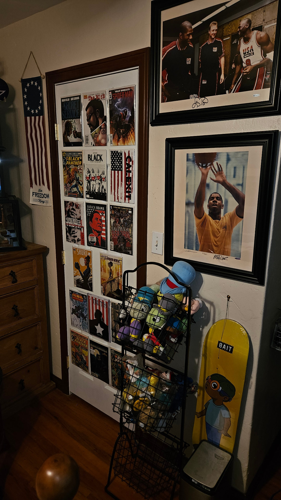 Door covered with comic art beside basketball photography.
